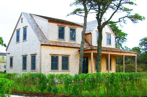 Medium sized classic two floor house exterior in Portland Maine with wood cladding.
