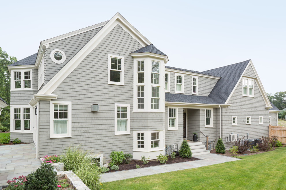 Inspiration for a large timeless gray two-story wood exterior home remodel in Boston
