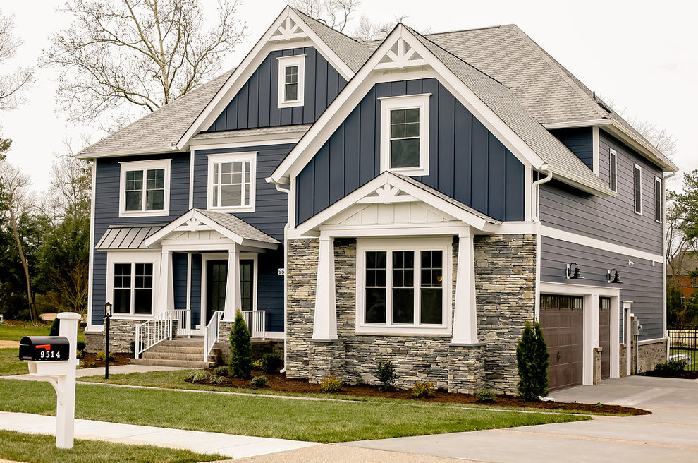 Large transitional blue two-story mixed siding house exterior photo in Other with a hip roof and a shingle roof