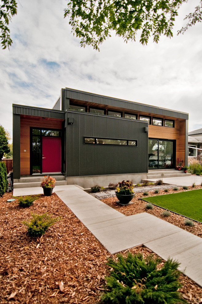 This is an example of a contemporary bungalow house exterior in Edmonton with metal cladding.