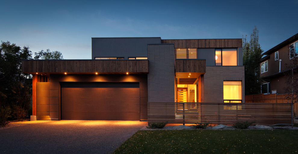 Inspiration for a large contemporary gray two-story brick exterior home remodel in Calgary