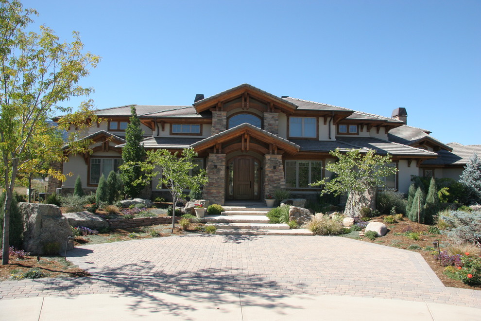 Large arts and crafts beige two-story mixed siding exterior home photo in Denver with a shingle roof