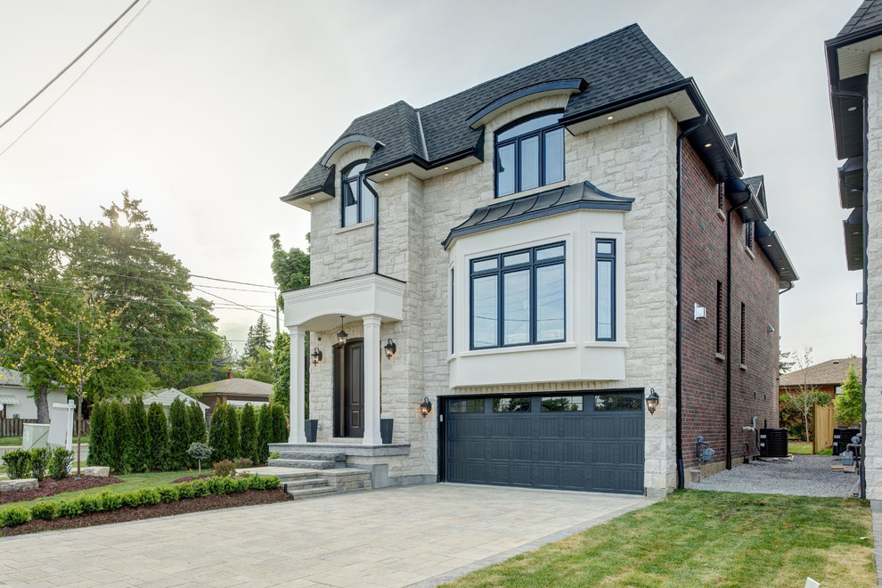 Mid-sized transitional beige two-story stone exterior home idea in Toronto with a hip roof