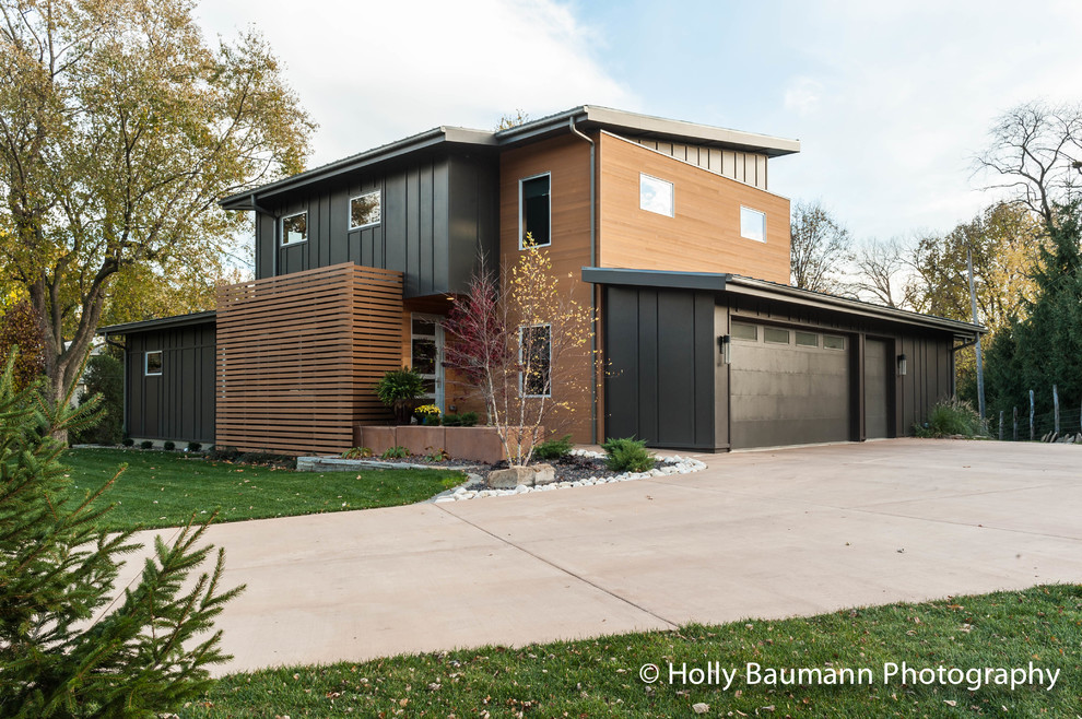 Large minimalist brown two-story wood exterior home photo in Chicago