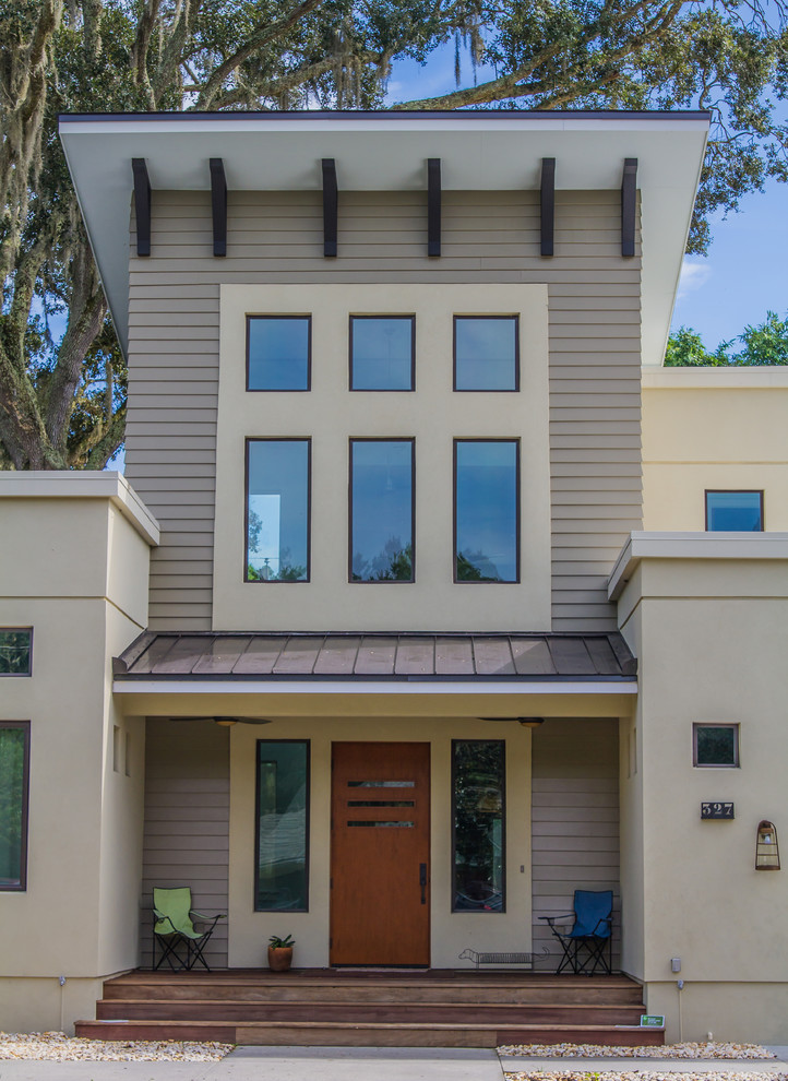 This is an example of a beige modern two floor concrete house exterior in Tampa.