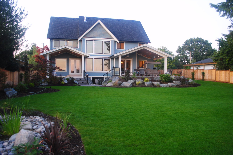 Inspiration for a large craftsman blue three-story mixed siding gable roof remodel in Vancouver