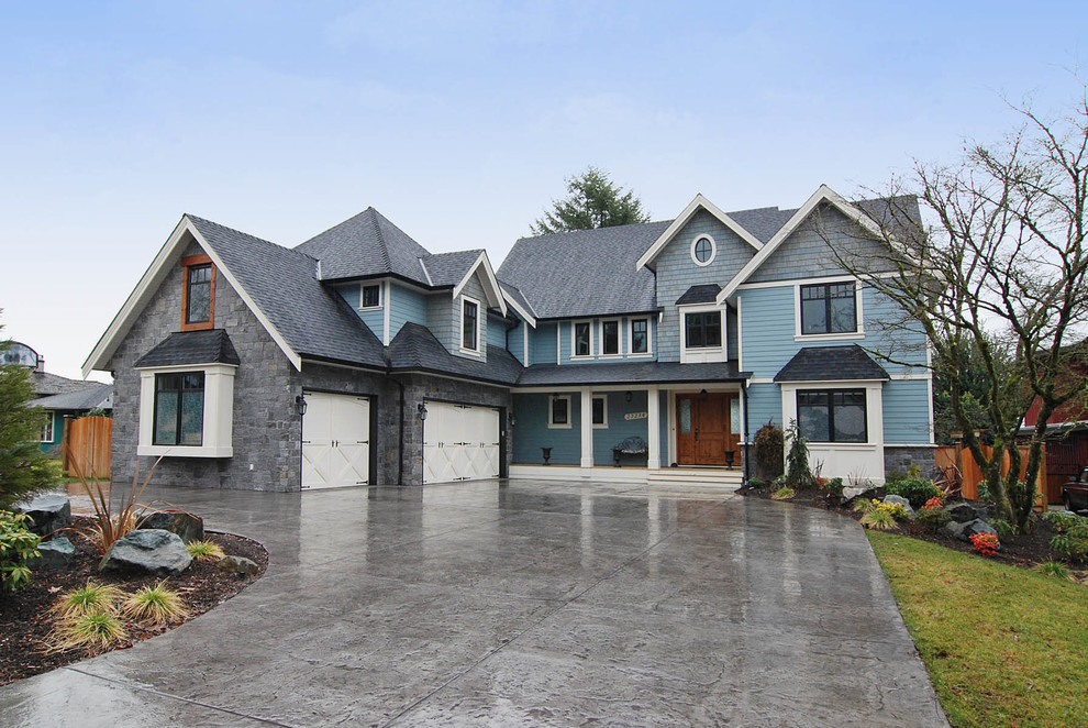 Design ideas for a large and blue classic house exterior in Vancouver with three floors, mixed cladding and a pitched roof.