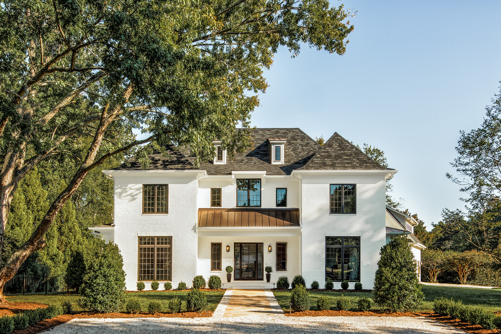 Huge transitional white two-story brick exterior home idea in Charlotte
