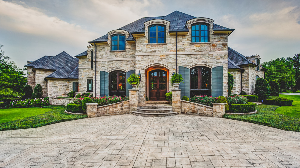 Huge traditional beige two-story stone gable roof idea in Little Rock