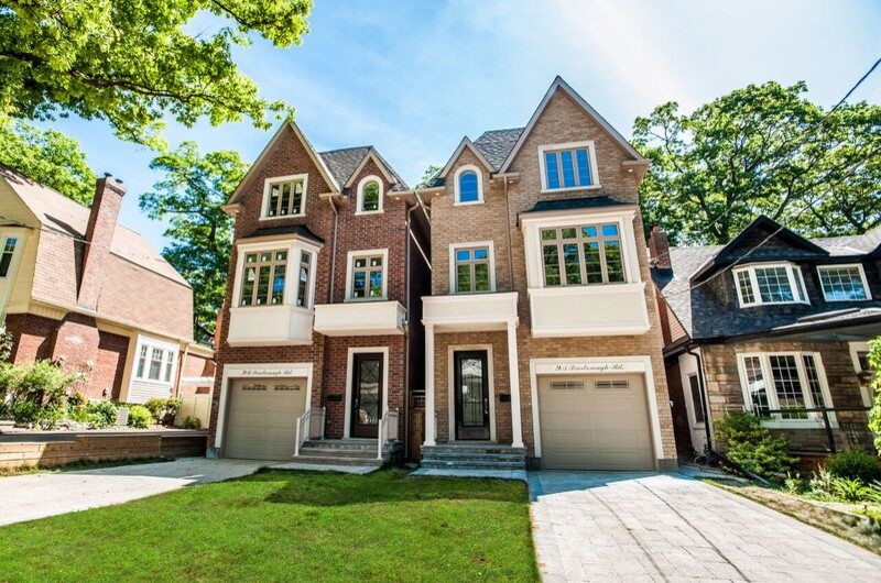 Mid-sized elegant beige three-story brick exterior home photo in Toronto