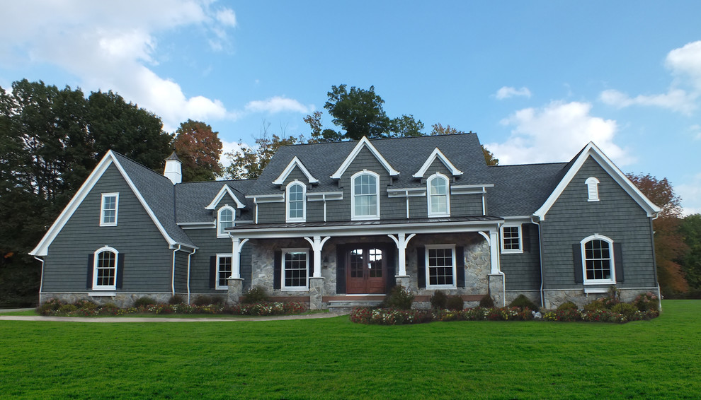 Inspiration for a large timeless gray two-story wood exterior home remodel in Cleveland with a shingle roof