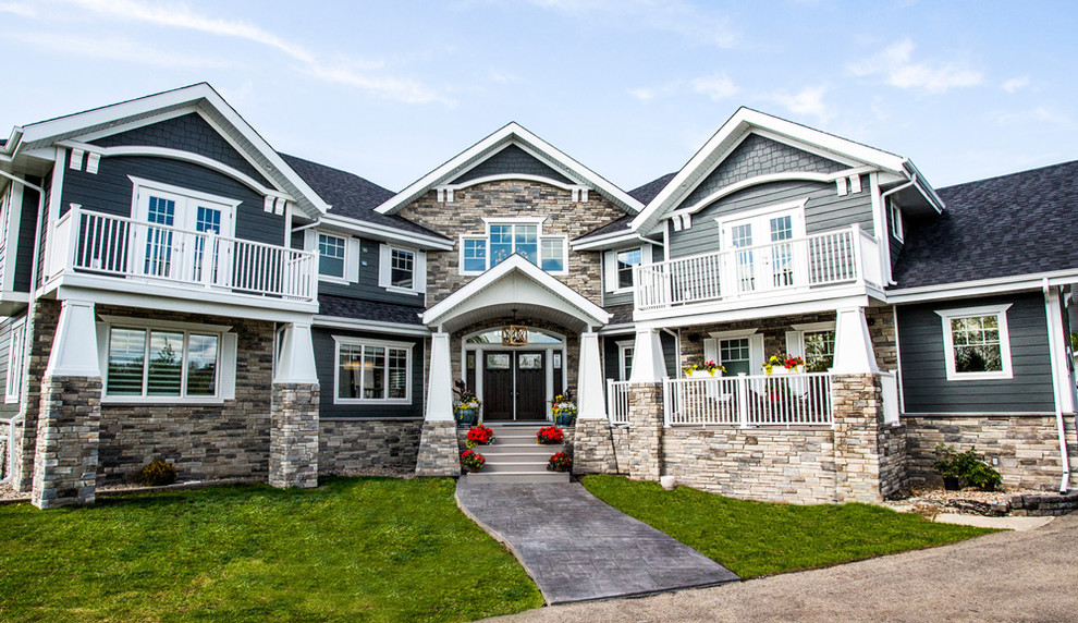 Mid-sized craftsman multicolored two-story mixed siding house exterior idea in Other with a shingle roof