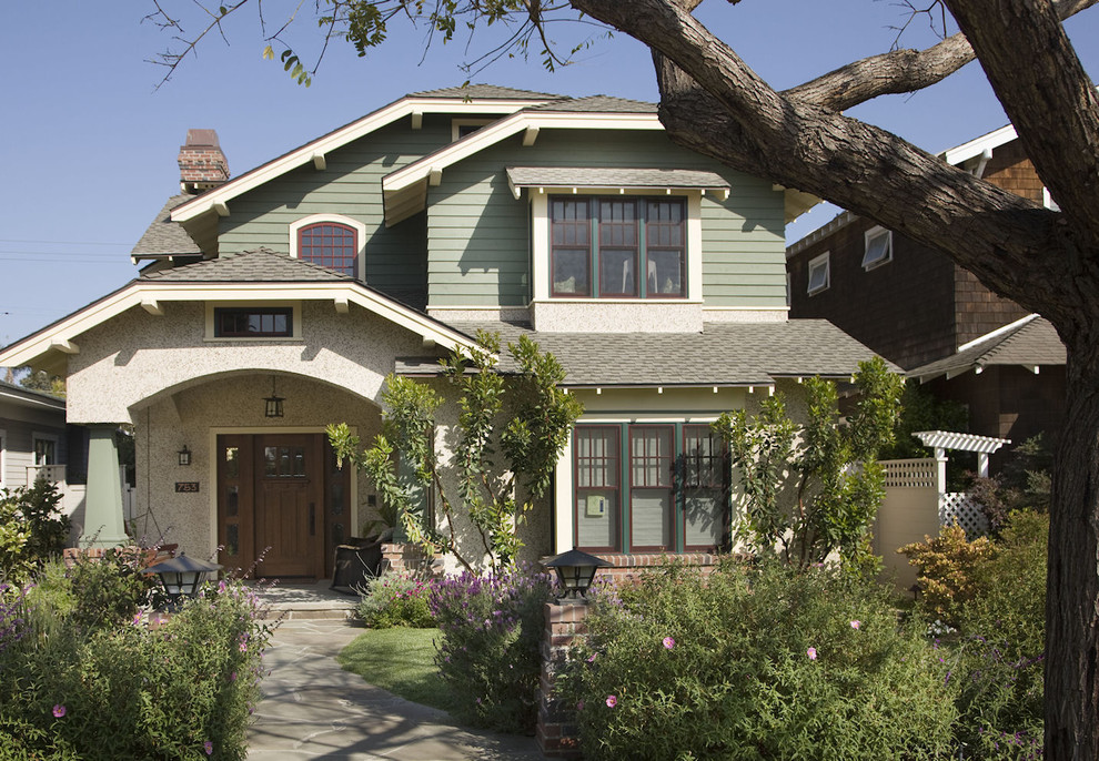 Inspiration for a traditional house exterior in San Diego with wood cladding and a half-hip roof.