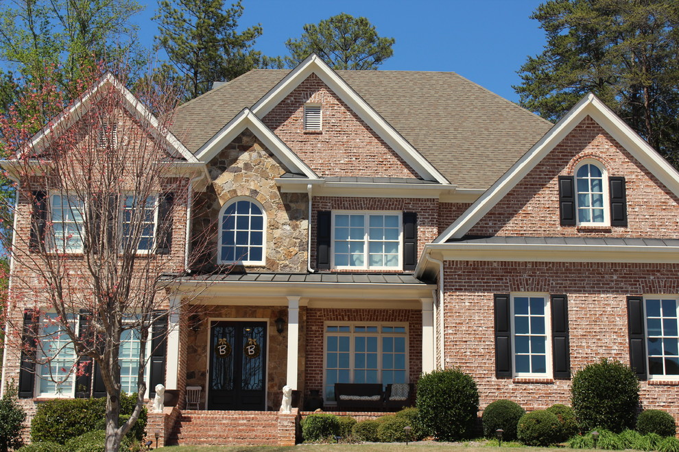 Photo of a large and red traditional two floor brick detached house in Atlanta with a pitched roof and a shingle roof.