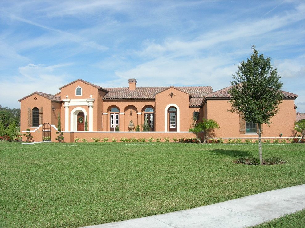 Mid-sized tuscan one-story stucco exterior home photo in Orlando