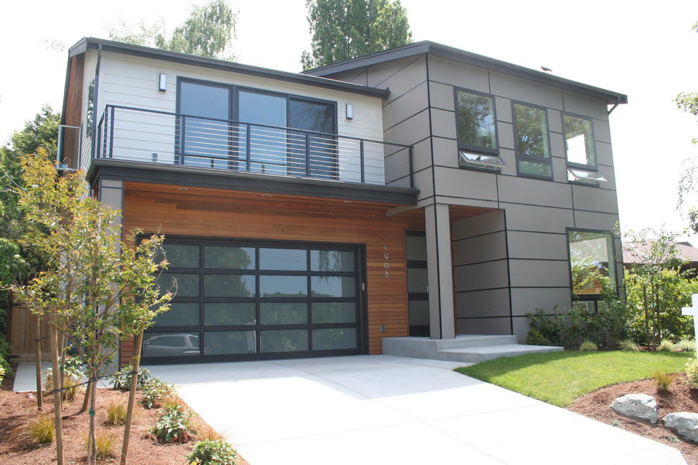 Exemple d'une grande façade de maison multicolore moderne à un étage avec un revêtement mixte.