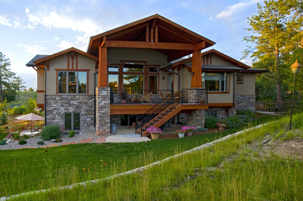 Large elegant beige one-story stucco exterior home photo in Denver