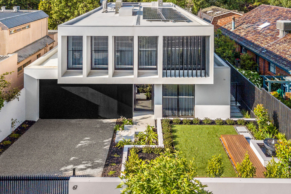 Photo of a large and white modern two floor render detached house in Melbourne with a flat roof and a metal roof.