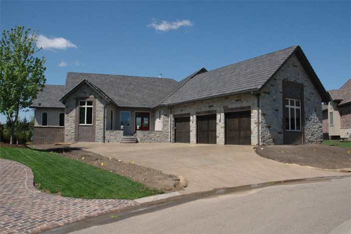 Inspiration for a medium sized and beige contemporary bungalow house exterior in Wichita with stone cladding.