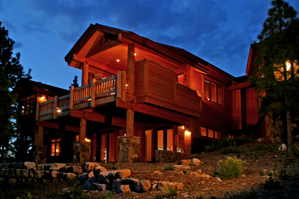 Photo of a large and brown traditional two floor house exterior in Phoenix with wood cladding.