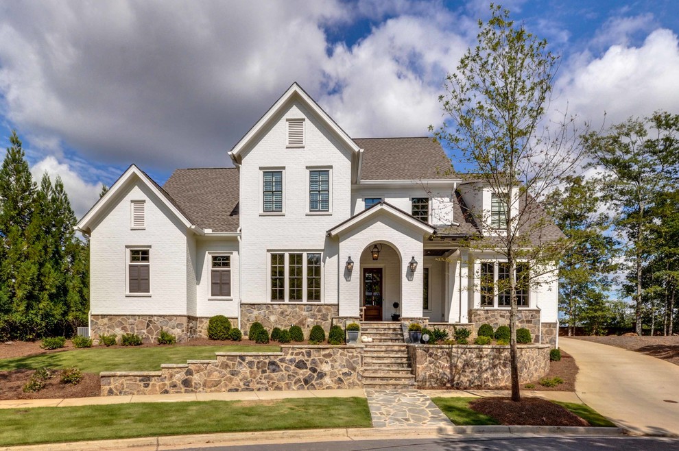 Inspiration for a timeless white two-story brick gable roof remodel in Atlanta