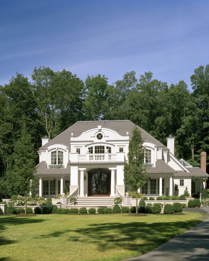 Idées déco pour une façade de maison blanche classique à un étage avec un toit à quatre pans.