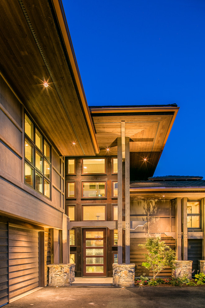 Example of a large trendy gray three-story mixed siding exterior home design in Seattle with a hip roof