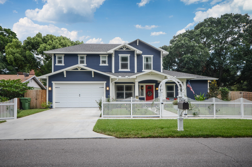 Medium sized and blue classic two floor detached house in Tampa with concrete fibreboard cladding, a hip roof and a shingle roof.