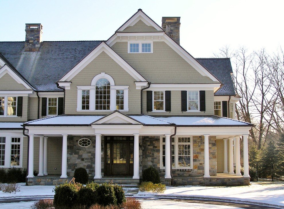 Large beige three-story wood gable roof idea in New York
