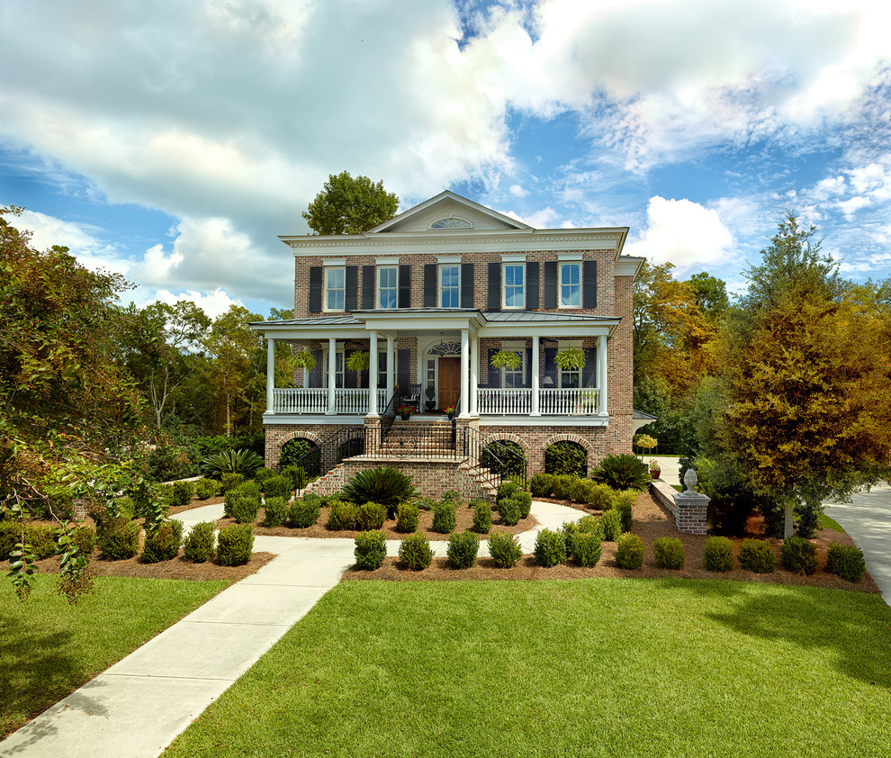 This is an example of a large traditional two floor brick house exterior in Charleston.