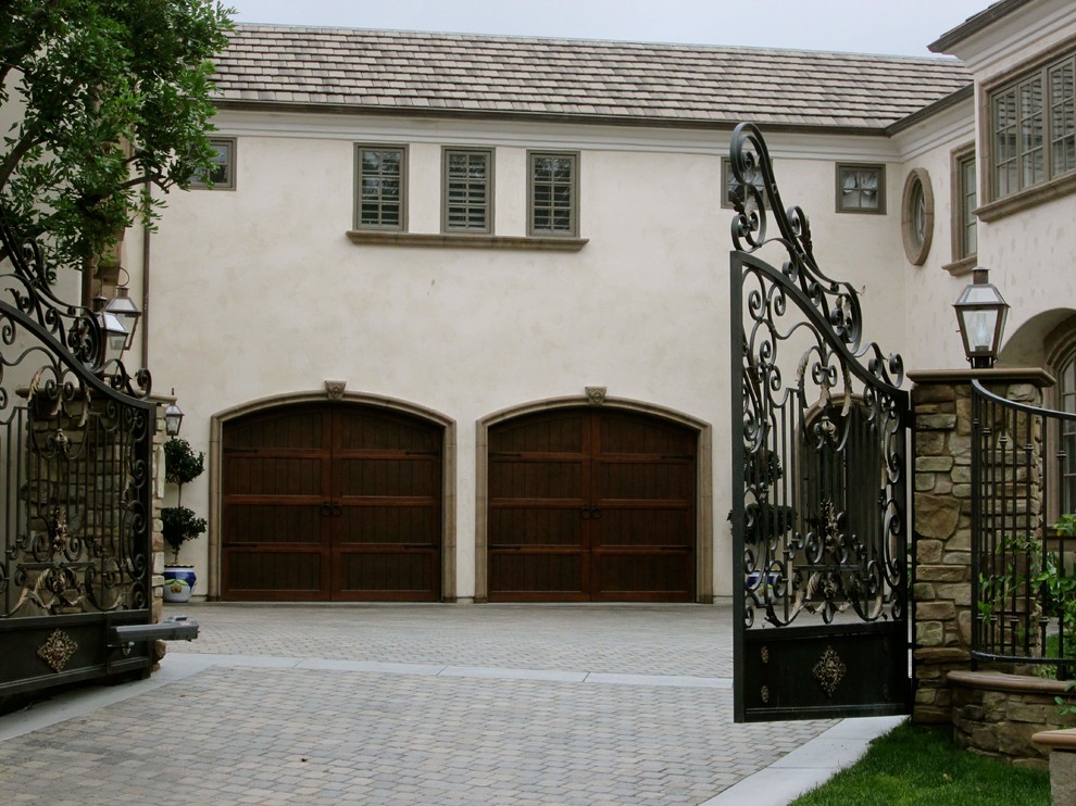 Large mediterranean white two-story stucco gable roof idea in Orange County