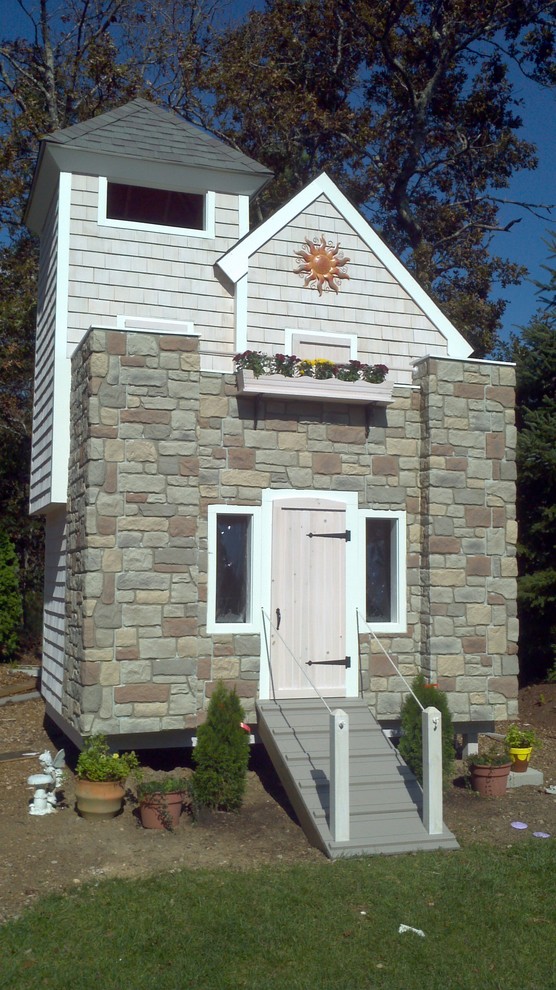 This is an example of a small and gey classic bungalow house exterior in Charlotte with stone cladding.