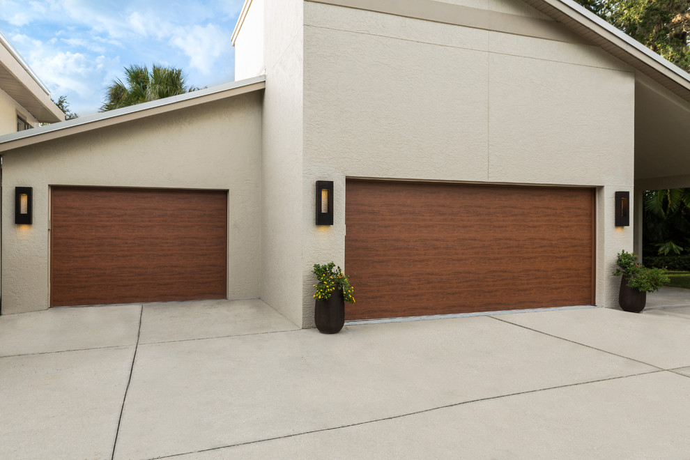 Design ideas for a large and beige traditional two floor concrete house exterior in Tampa.