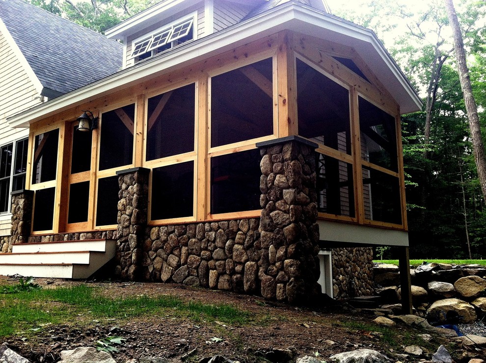 На фото: двухэтажный, коричневый дом среднего размера в стиле рустика с облицовкой из камня и двускатной крышей