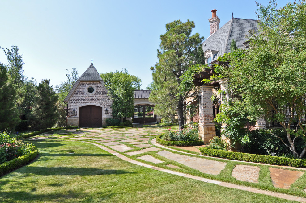 This is an example of a classic brick house exterior in Dallas with a half-hip roof.