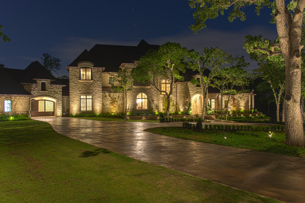 Large mediterranean beige two-story stone exterior home idea in Dallas with a shingle roof