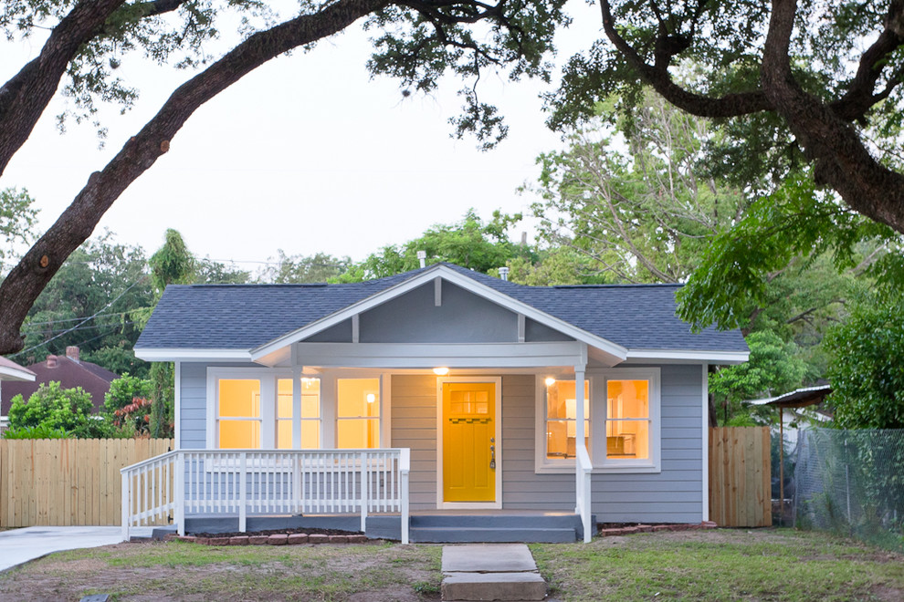 Photo of a medium sized and gey classic bungalow house exterior in Houston with concrete fibreboard cladding.