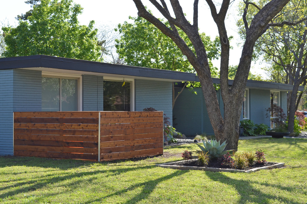 Small and blue retro bungalow house exterior in Dallas.