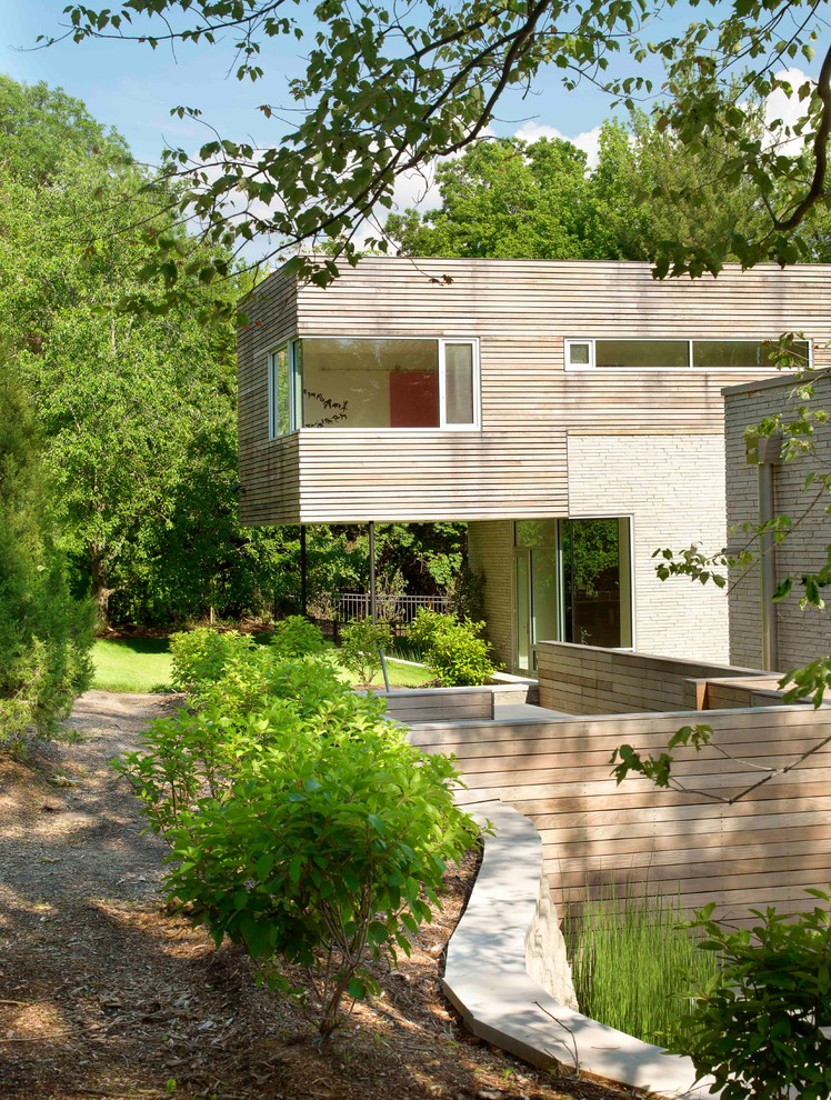 Contemporary two floor house exterior in St Louis with wood cladding and a flat roof.