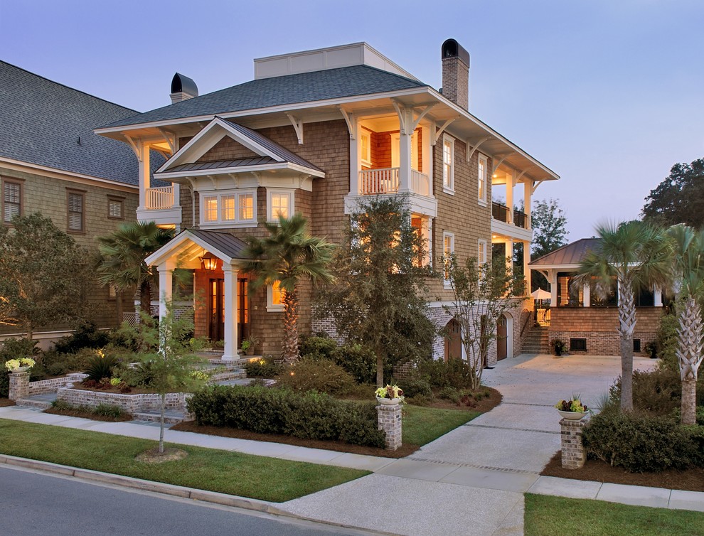 Design ideas for a large and brown beach style detached house in Charleston with wood cladding, a hip roof, a mixed material roof, three floors, a grey roof and shingles.