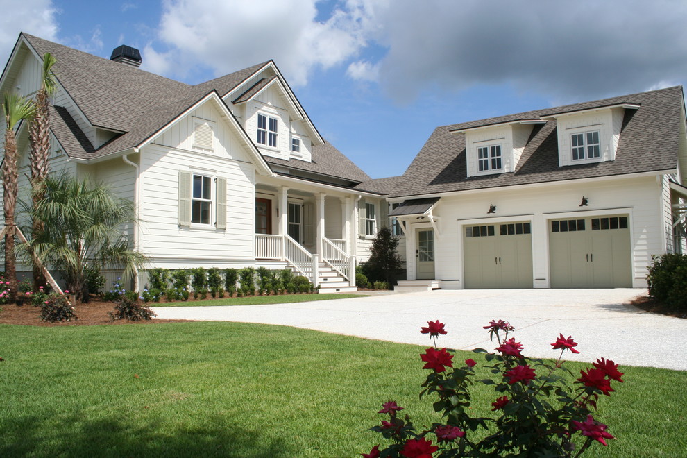 Example of a large beach style white two-story wood house exterior design in Charleston with a shingle roof
