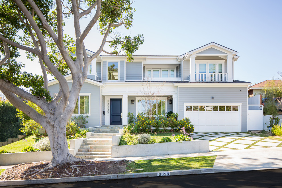 Inspiration for a coastal blue two-story exterior home remodel in Orange County with a shingle roof