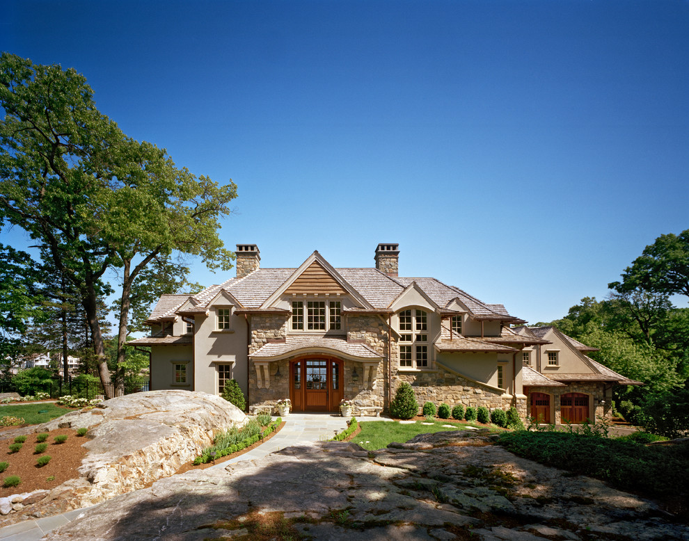 This is an example of a classic house exterior in New York with stone cladding and a hip roof.