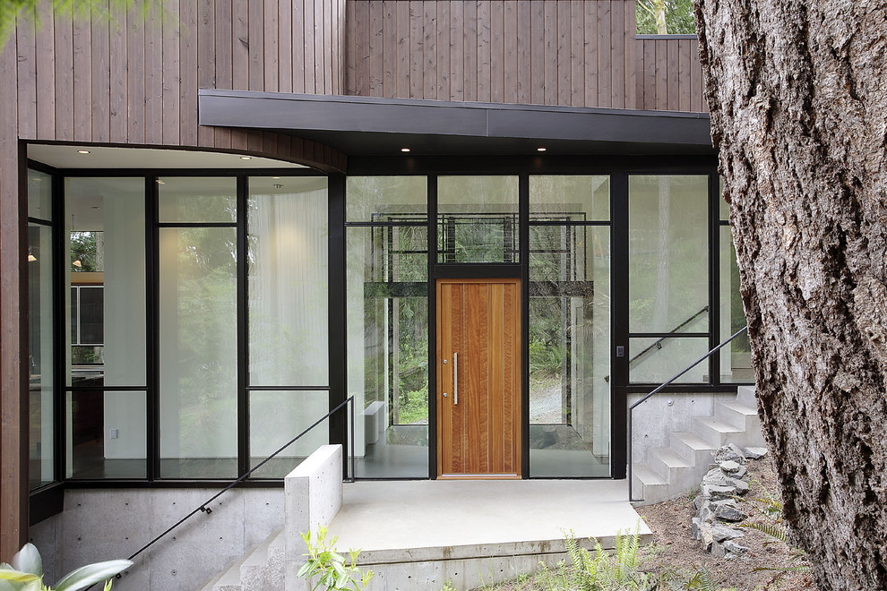 Ejemplo de fachada gris moderna de tamaño medio de dos plantas con revestimiento de madera