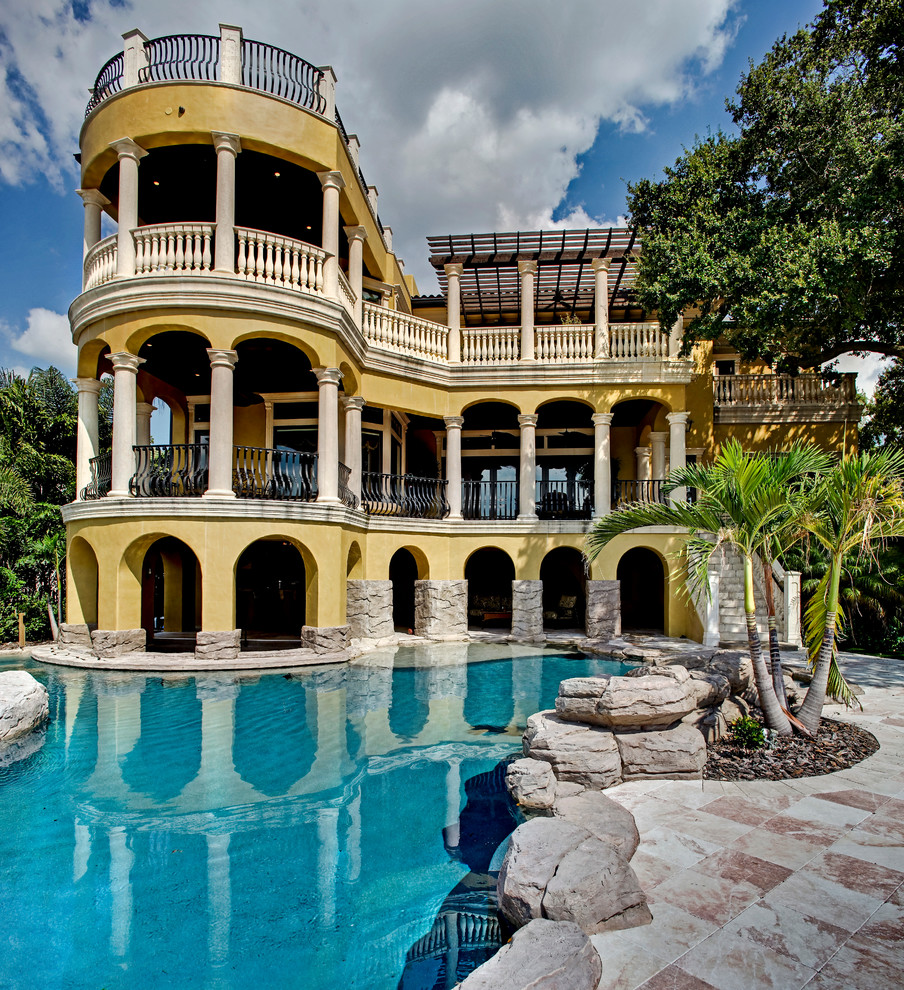 Example of a tuscan three-story exterior home design in Tampa