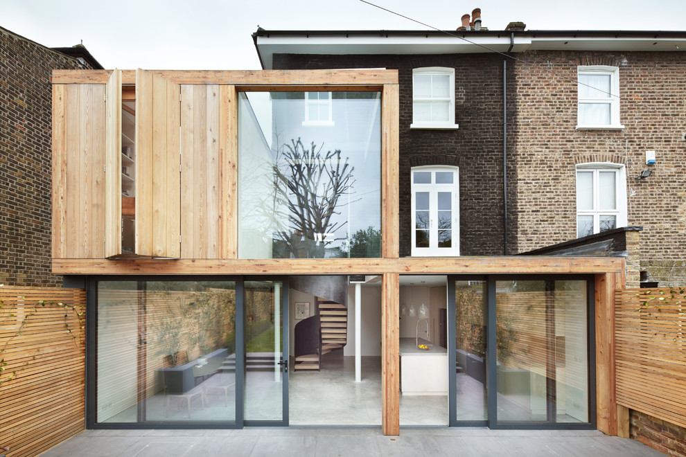 Zweistöckige Moderne Doppelhaushälfte mit Metallfassade, brauner Fassadenfarbe, Flachdach und Blechdach in London