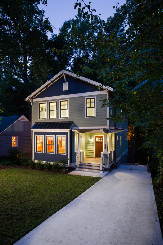Medium sized and green traditional house exterior in Atlanta with three floors, concrete fibreboard cladding and a pitched roof.