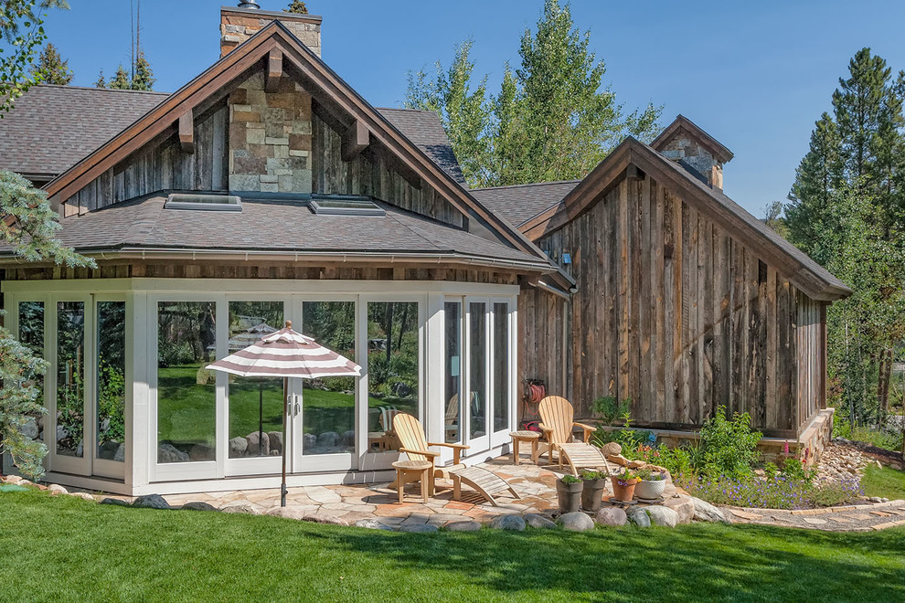 Example of a mountain style two-story wood exterior home design in Denver