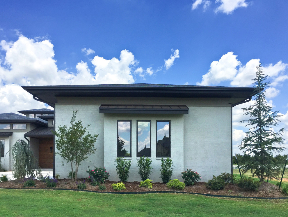 Ejemplo de fachada gris contemporánea de tamaño medio de dos plantas con revestimiento de ladrillo y tejado a cuatro aguas