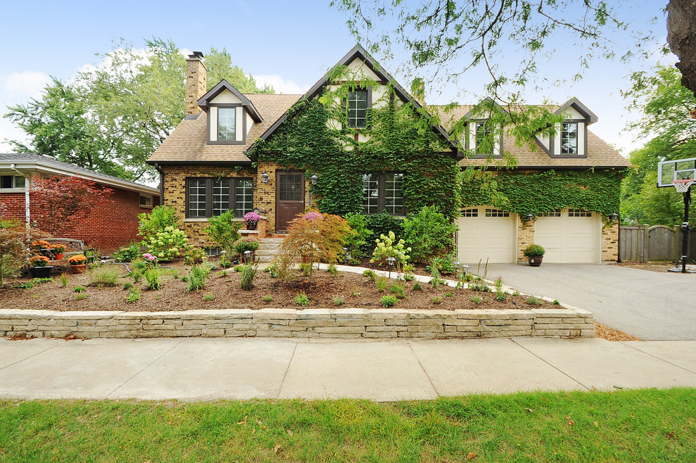 This is an example of a beige rural two floor brick house exterior in Chicago.